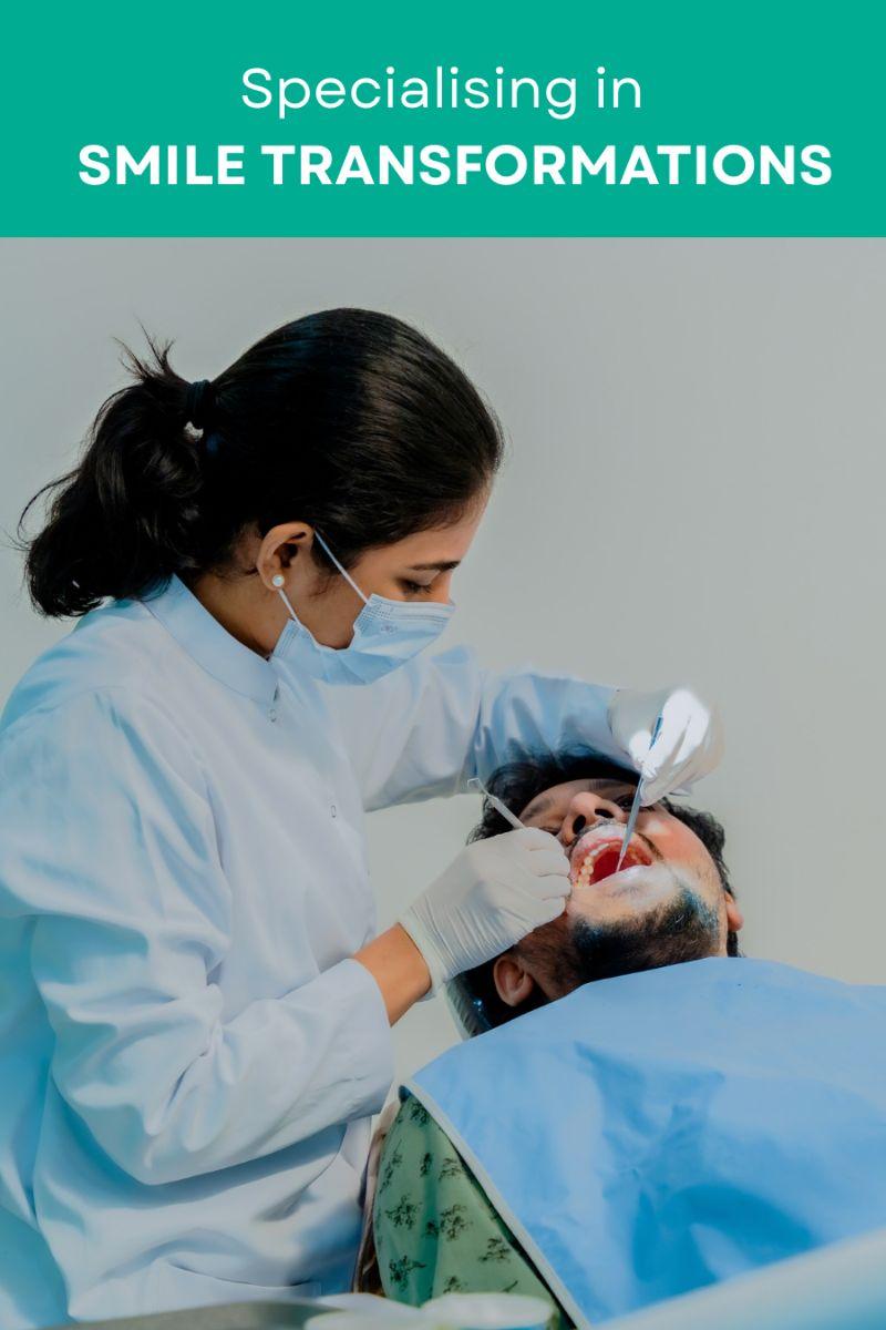 Dentist wearing mask and gloves treats a patients open mouth during a smile transformation procedure